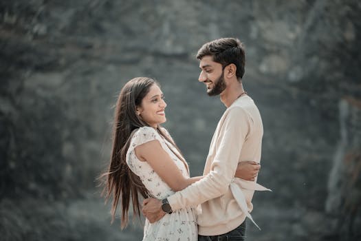 A joyful couple embraces outdoors, capturing a genuine moment of connection.