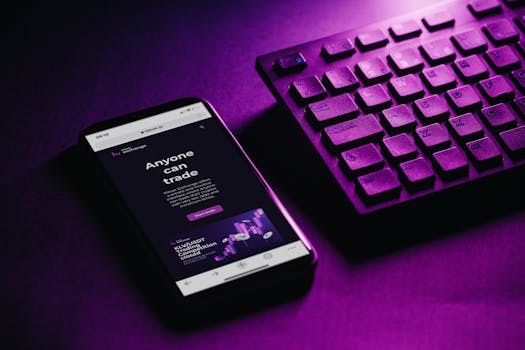 Close-up of a smartphone and keyboard with a purple hue, embodying modern technology and connectivity.
