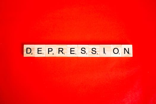 Word depression spelled with letter tiles on vibrant red background, highlighting mental health theme.